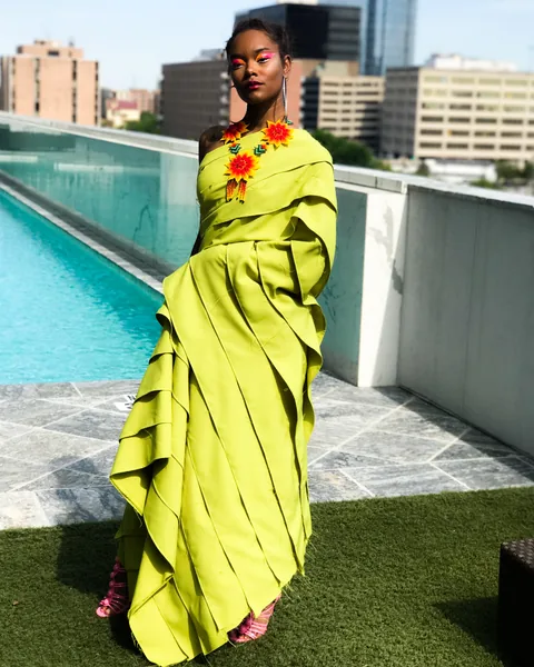 Existing editorial portfolio photograph of a model in a green outfit outdoors