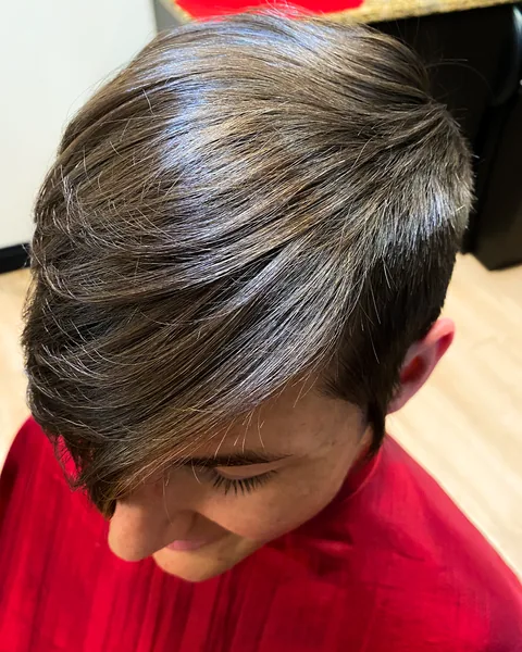 Side swept short hairstyle with a smooth tapered silhouette