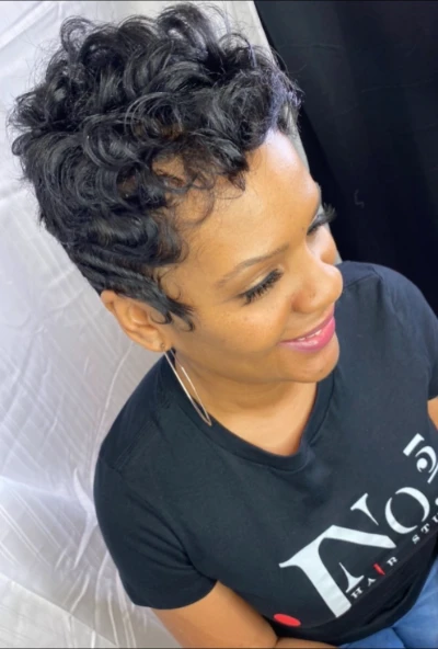 Short curly pixie with a tapered nape, photographed in a J No.5 studio shirt